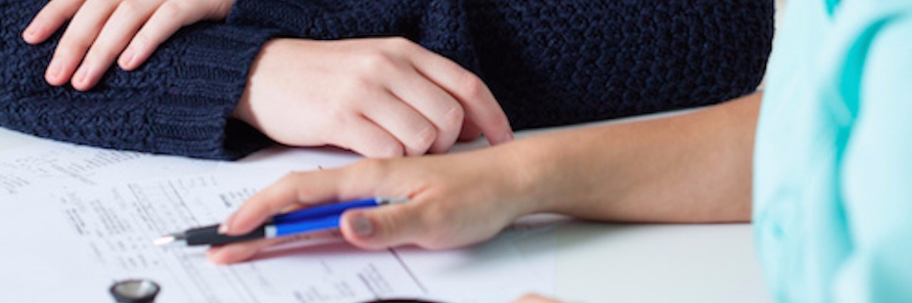 My Relationship With My Oncology Team During Breast Cancer Treatment patient and doctor at table, with stethoscope and papers on table