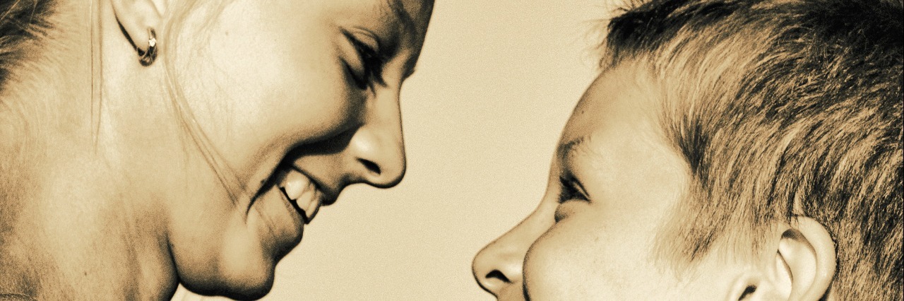 To My Brother on the Autism Spectrum as I Move Away From Home Sepia photo with a profle of sister 9who is older) and brother looking at each other and smiling.