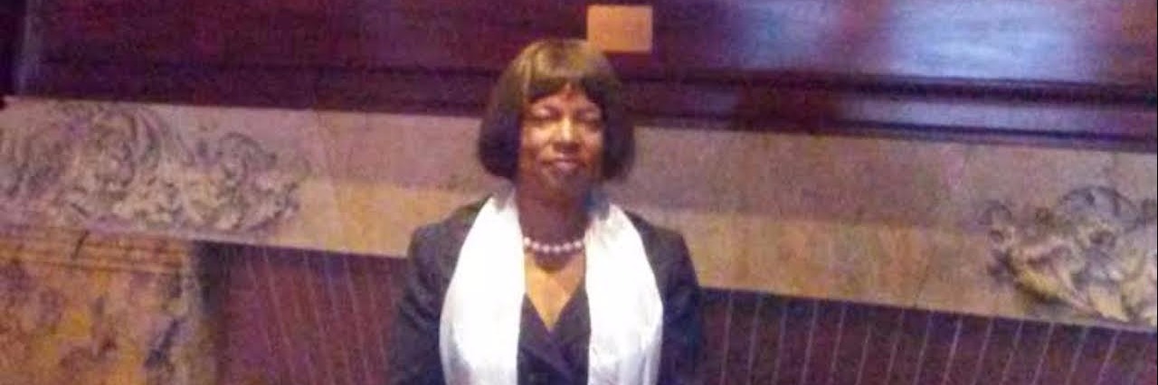 Rheumatoid Arthritis, Chronic Pain: Invisible Aspects of Illness woman posing in front of a large framed painting over a fireplace