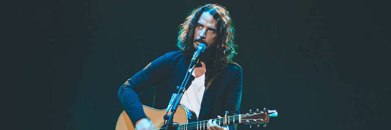 Chris Cornell playing guitar on stage