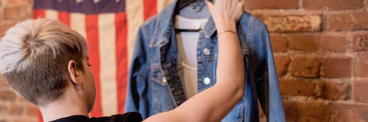 The Garment Project Helps People With Eating Disorders Clothes Shop girl looking at jean jacket
