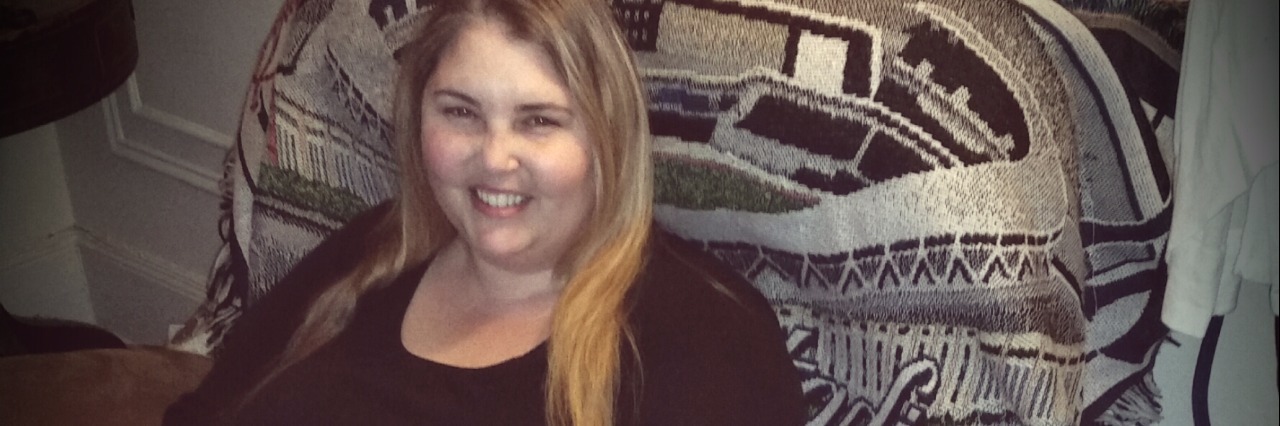 Not Feeling 'Lucky' With Sarcoidosis woman sitting in an armchair and typing on her computer next to table full of medication bottles