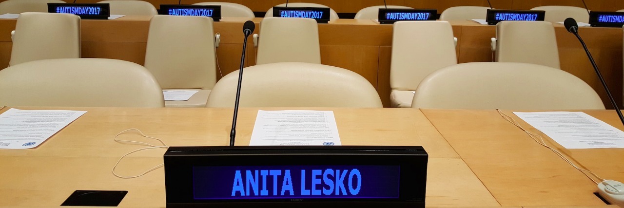 What I Learned at the United Nations on World Autism Awareness Day UN tables and chairs with a digital nameplate reading Anita Lesko and digital name plates on tables in the background that say Autism Day 2017