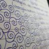 spiral doodles in blue pen in lined notebook