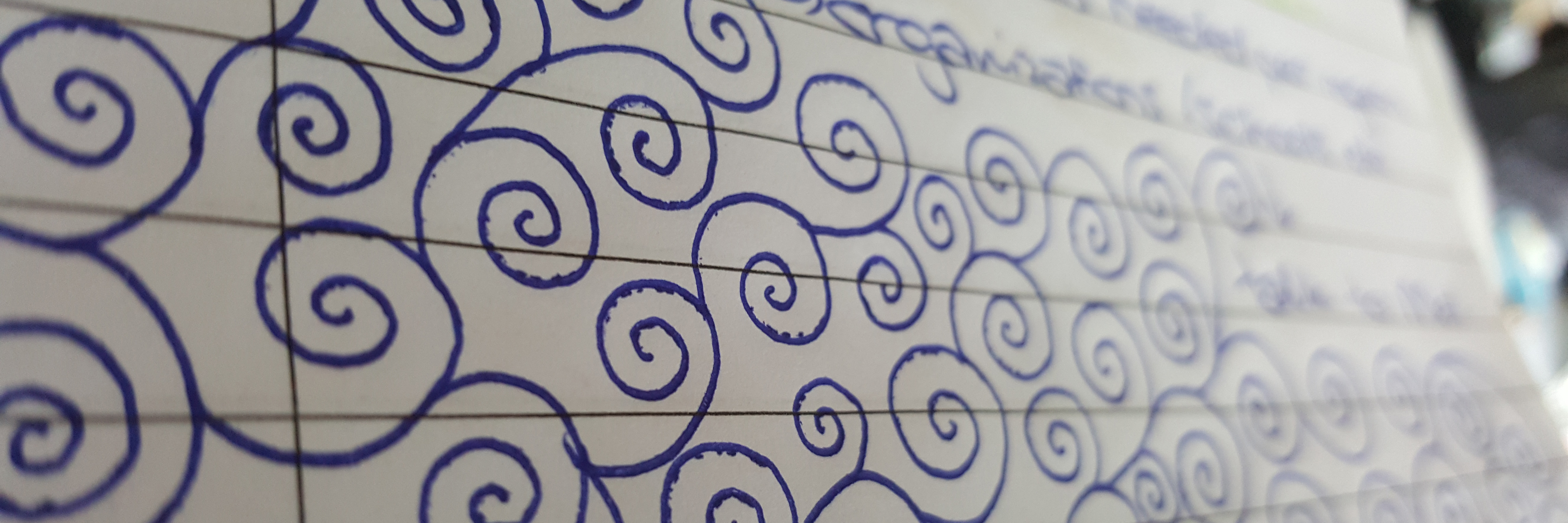 How Doodling Has Helped Me With Mindfulness and Anxiety spiral doodles in blue pen in lined notebook