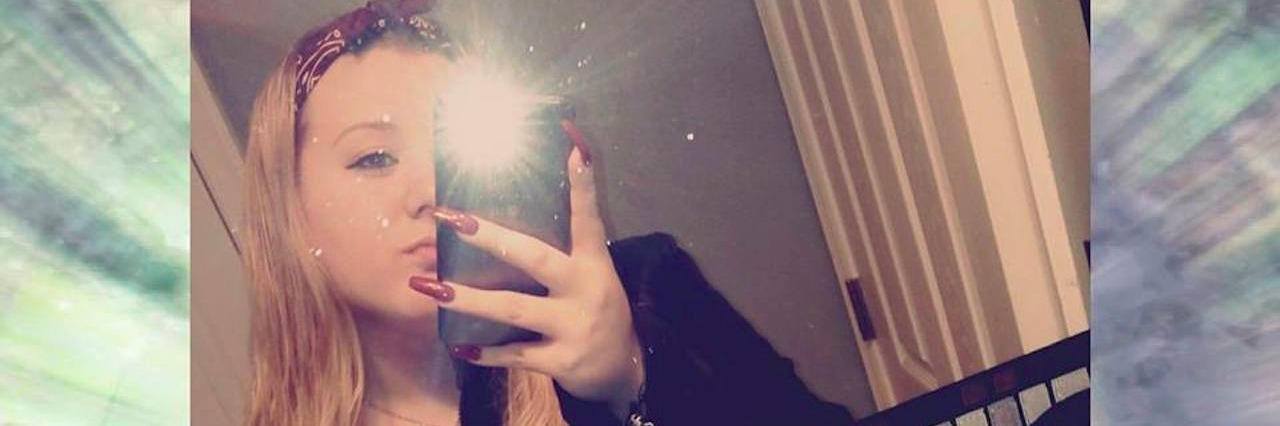 The Selfie I Took Before Attempting Suicide A woman taking a mirror selfie