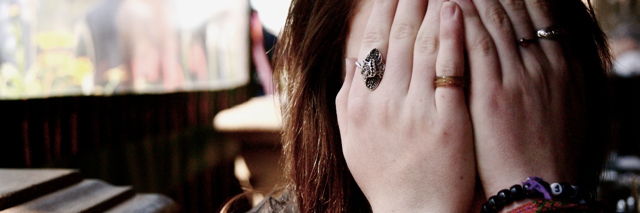 What Mornings Are Like as a Student With Anxiety female student wearing bracelets covering face with hands