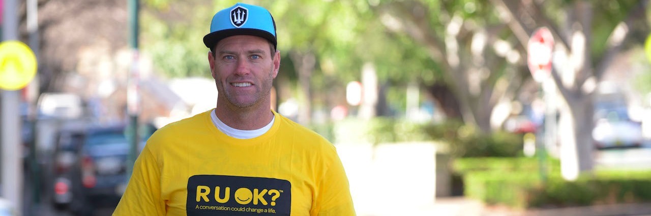 Bruce Hoppo Hopkins From Bondi Beach Talks About Suicide A man wearing an R U OK? t-shirt standing in the streat