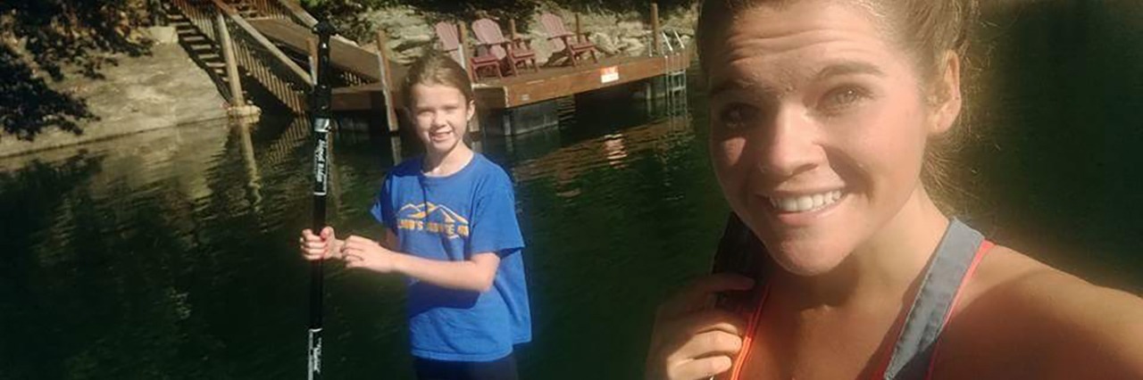 Why I Won't Hide My Eating Disorder From My Little Sister young woman with little sister smiling beside river