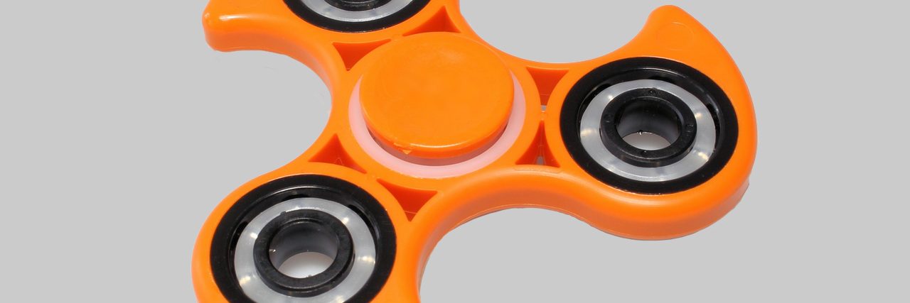 Photo of an orange fidget spinner