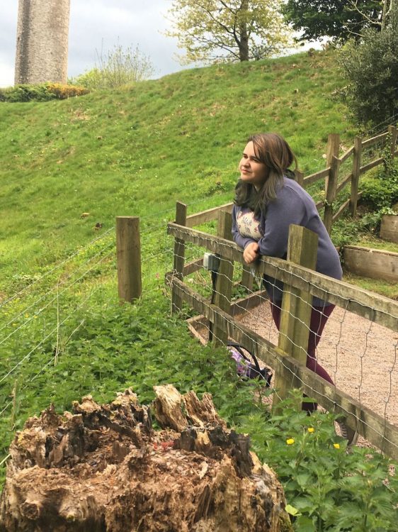 woman leaning on a railing looking at a park