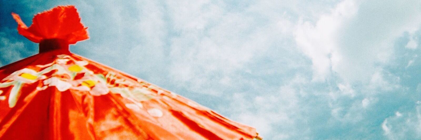 Fibromyalgia: Finding Joy When You Live With Chronic Pain orange umbrella against a blue sky