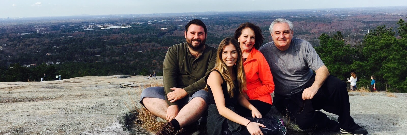 Being Diagnosed and Learning to Live With Narcolepsy family sitting on the top of a mountain after a hike