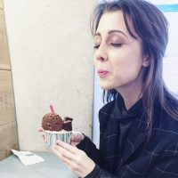 the author holding a cup of ice cream