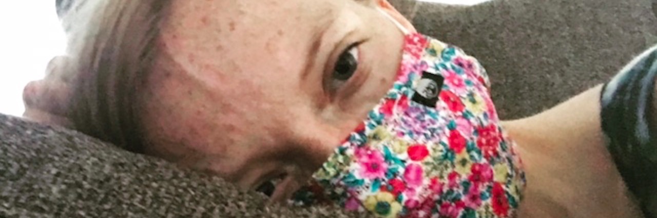 Letter to the Doctors Who Denied My Lyme Disease aubrey winkie laying on couch wearing surgical mask