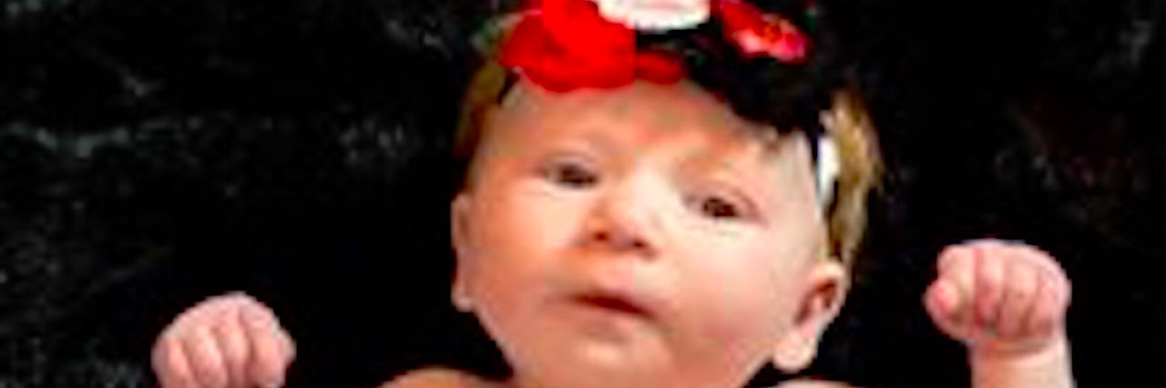 My Journey as a New Heart Mom baby wrapped in heart blanket