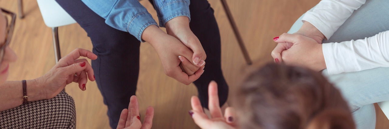 Why I'm Not Embarrassed to Go to Therapy Four women sitting in chairs in a circle during a group therapy session