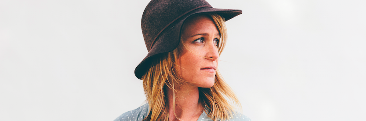 Postpartum Depression Made Motherhood Something I Didn't Want Anymore woman in hat