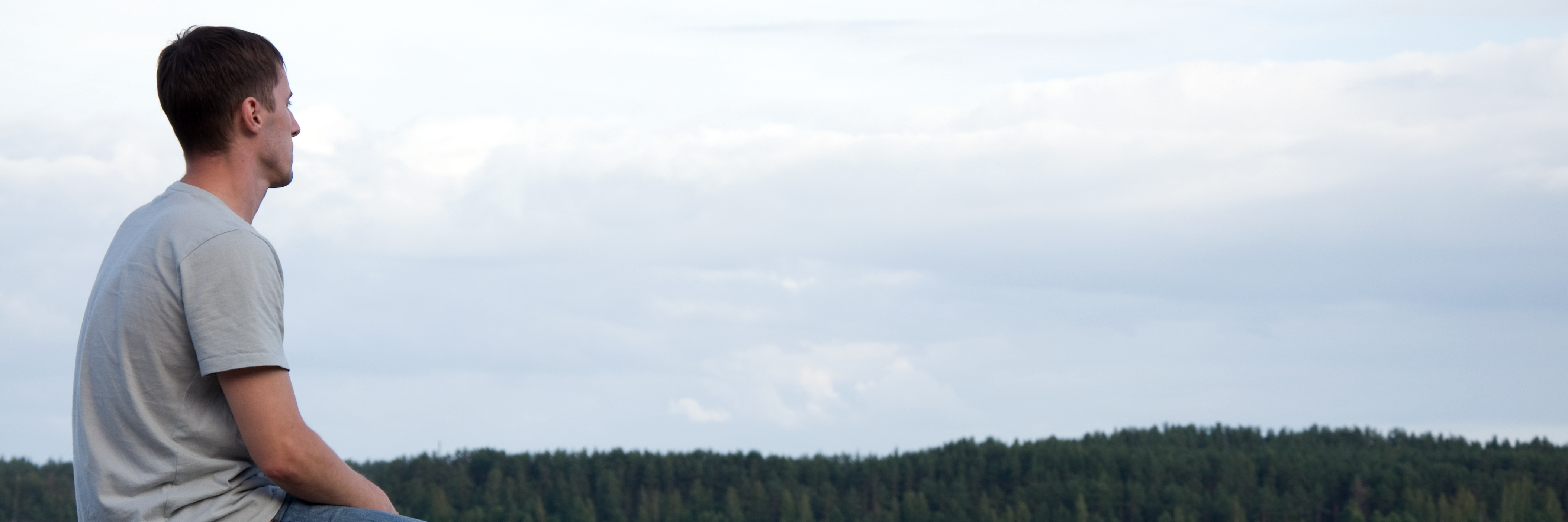 What Happiness Is When You Have Depression young man sitting alone by water