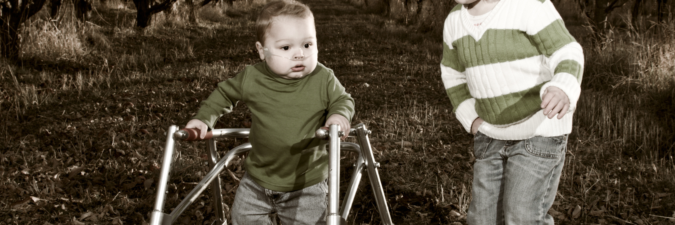 Pediatric Stroke Awareness During Stroke Awareness Month Boy with walker and sister playing in an orchard.