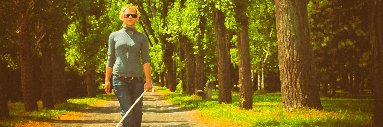 Blind woman walking in a park.