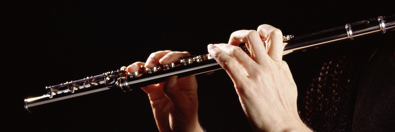 Living a Musician's Life With Fibromyalgia Person playing the flute.