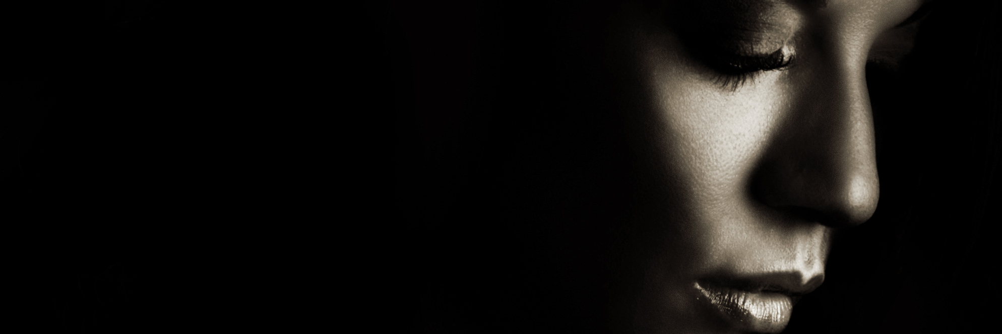 How to Address the Connection Between Chronic Pain and Suicide woman's profile in shadow on black