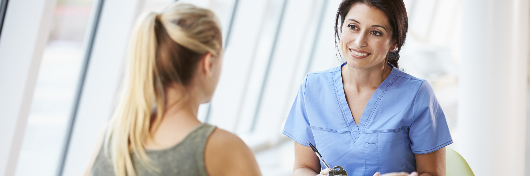 How to Be a Great Nurse Practitioner and Help Undiagnosed Patients young woman talking to a nurse