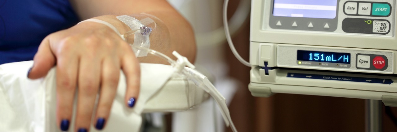 woman receiving medication through an iv drip