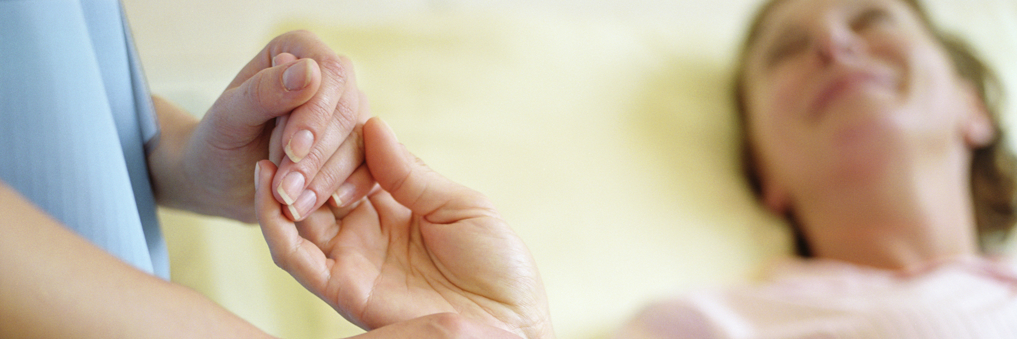 Primary Immunodeficiency: Nurse Offering Support and Companionship nurse holding a woman's hand and checking her pulse