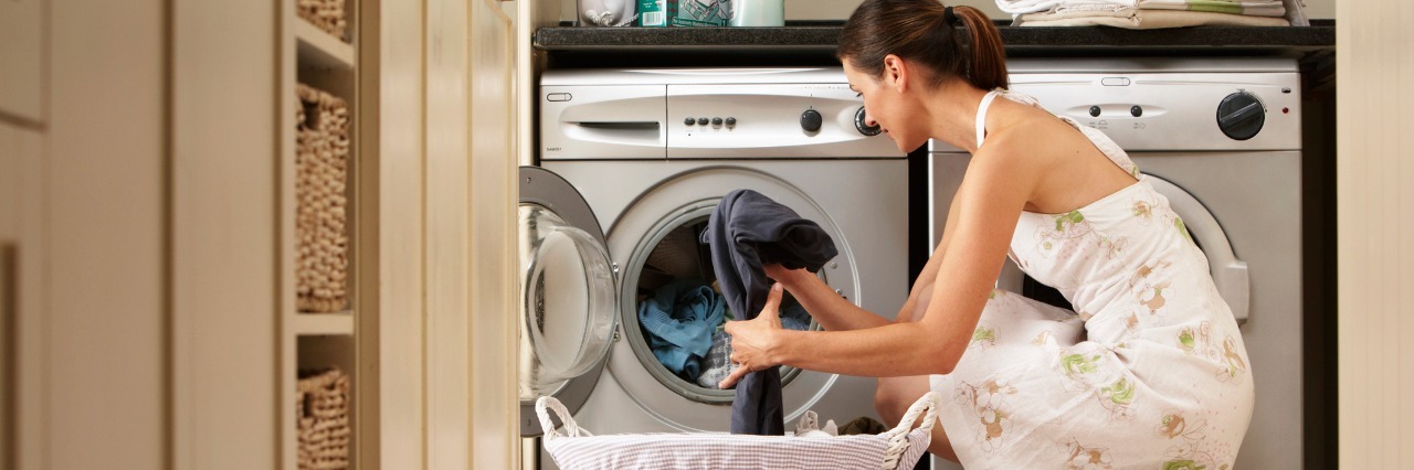 woman loading a washing machine