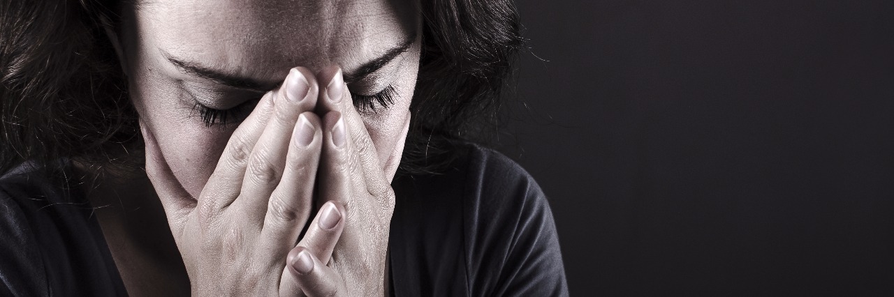 When You're Constantly Feeling Ashamed of Your Depression woman with hands over her face crying