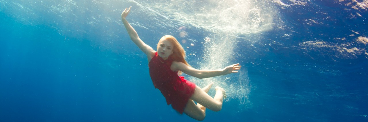 A woman swimming underwater