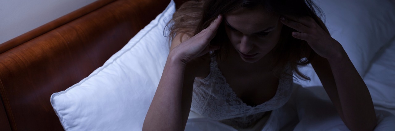 Depression Affecting My Sleep woman in bed having trouble sleeping next to clock reading 3 a.m.