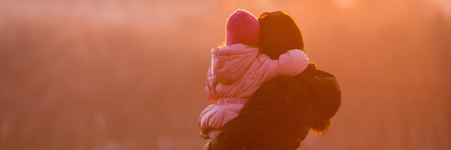 Teaching My Kids About Their Food Allergies and Safety Mother holding daughter, looking at water landscape