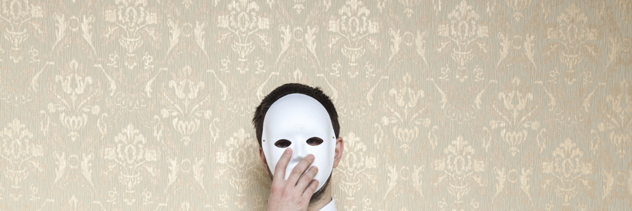 businessman hiding behind the mask