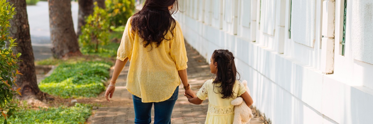 What I Wish My Mom and I Talked About When We Talked About Bullying Mother and daughter holding hands, walking down sidewalk