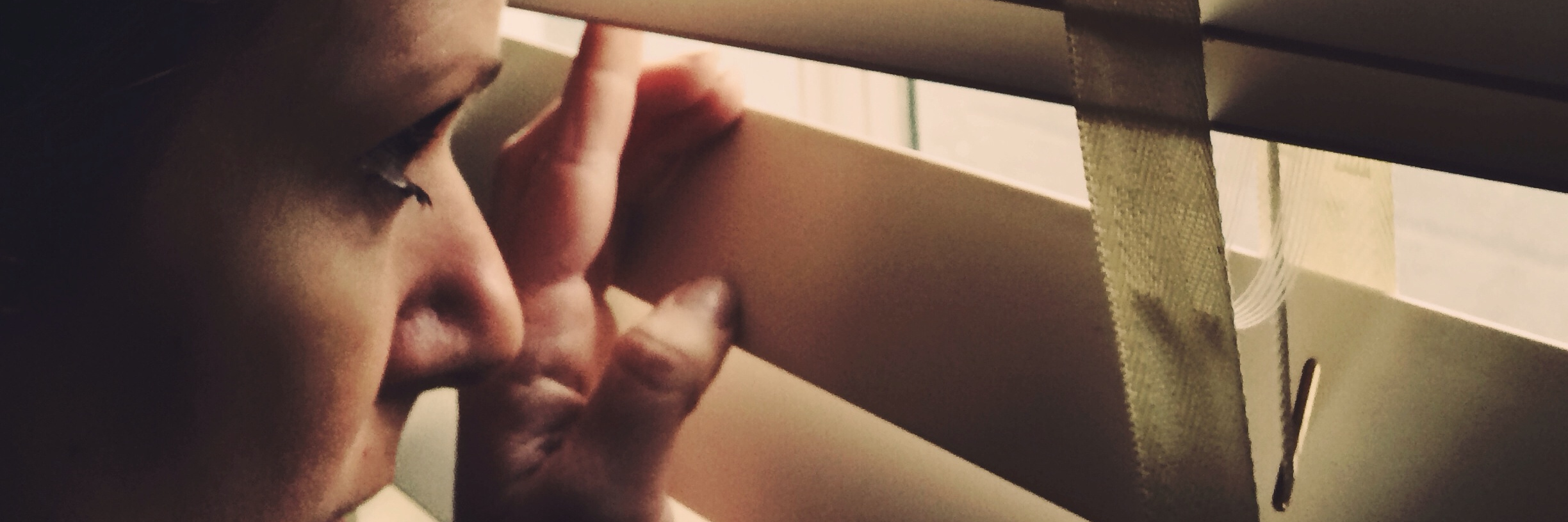 Negative Effects of Being Fearful of Chronic Pain woman peeking through her blinds