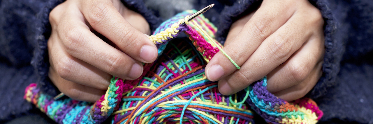 a close up on hands knitting