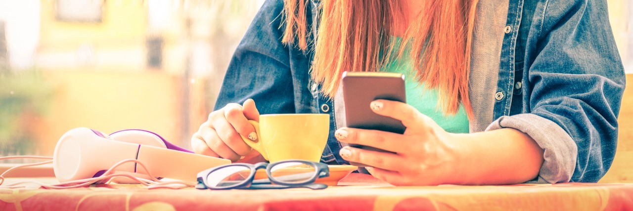 Why People Who Are Chronically Ill Are Judged for Posting on Facebook Vintage filtered portrait of serious pensive young woman with smartphone