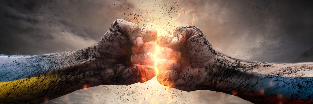 Anxiety and Depression: The War in My Head Close up of two fists hitting each other over dramatic sky