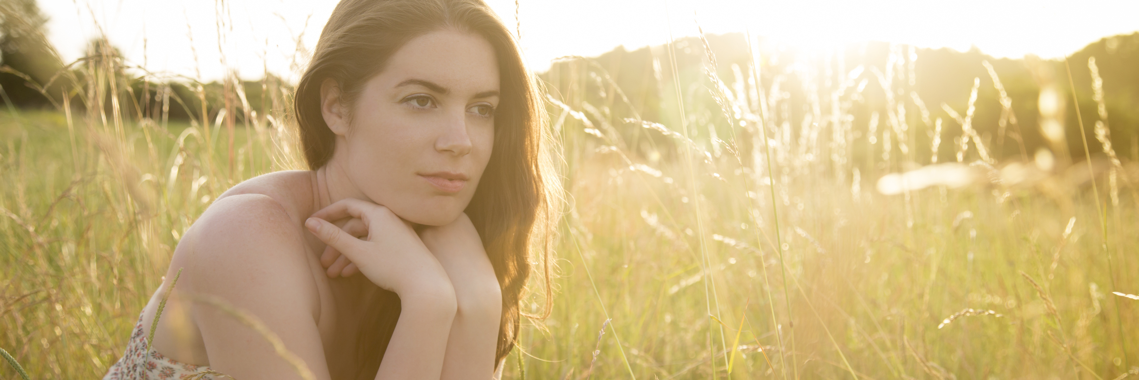 The Unexpected Way That Reaching out to a Therapist Changed My Life young woman in field in sunshine