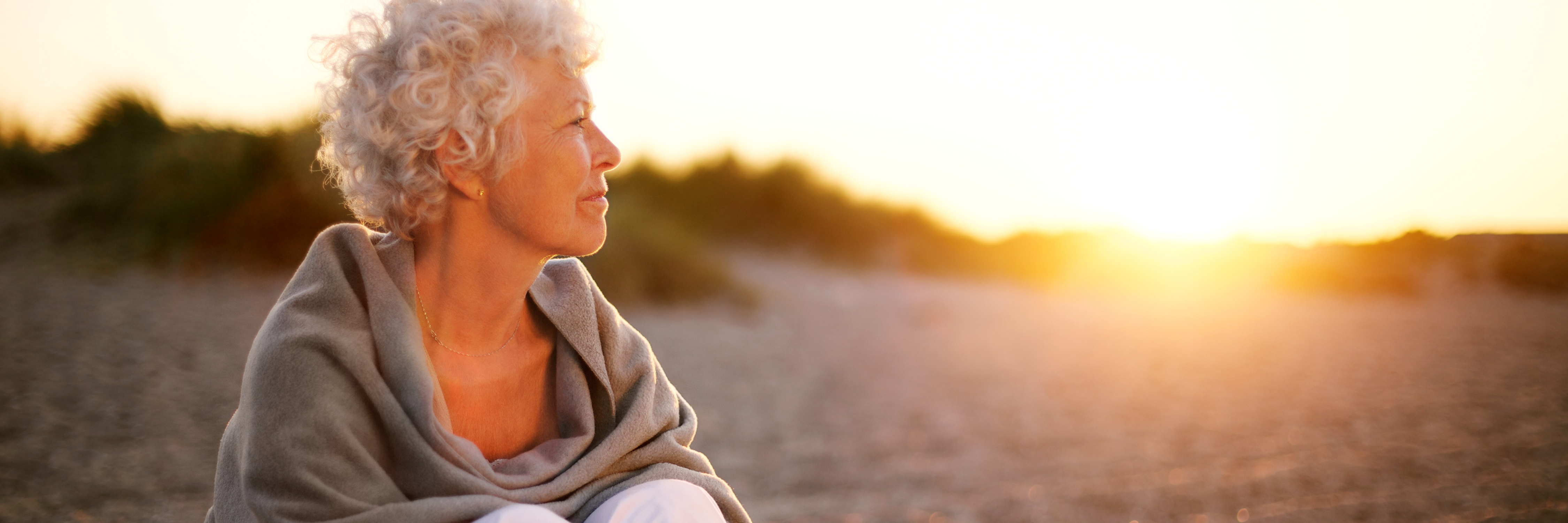 How I Have Learned to Manage My Depression as an Senior Person senior woman sitting on beach looking at horizon