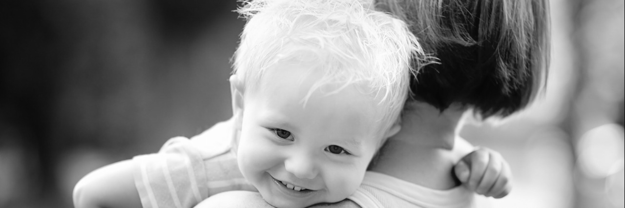 A Letter to My Autistic Grandson on Your Birthday Black and white photo of woman holding toddler