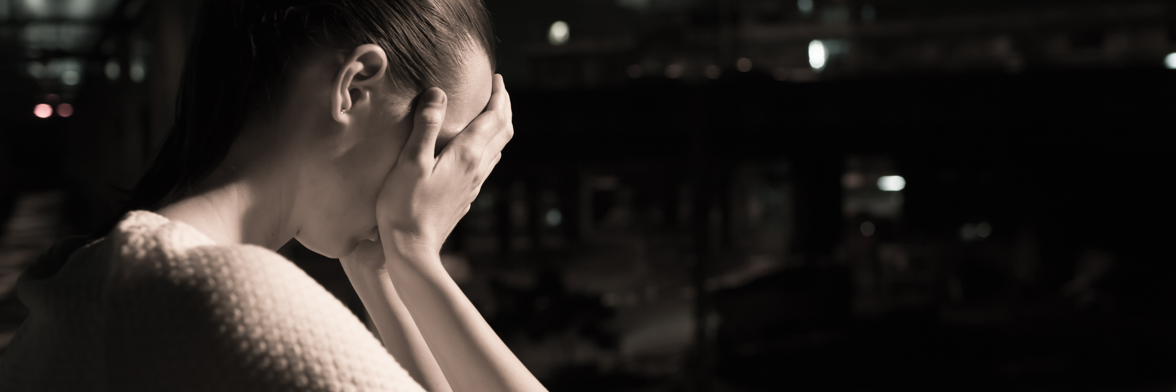 When Anxiety Make You Apologize for Everything sepia photo of sad woman in dark area resting face in hands