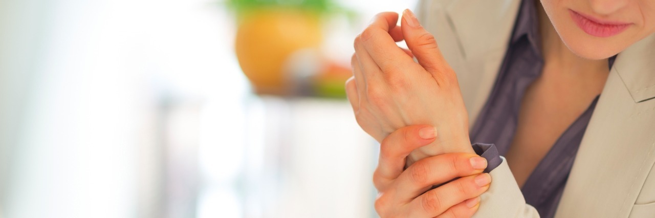 3 Things Doctors Never Told Me About Arthritis Pain Closeup on business woman with wrist pain