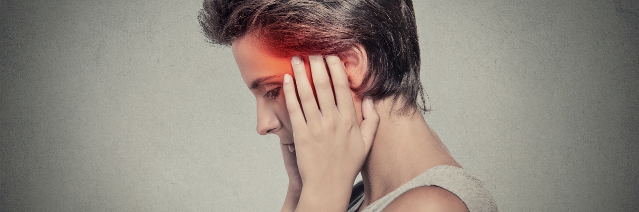 What I Learned About Concussions From a Head Injury side view of a woman holding her head in pain