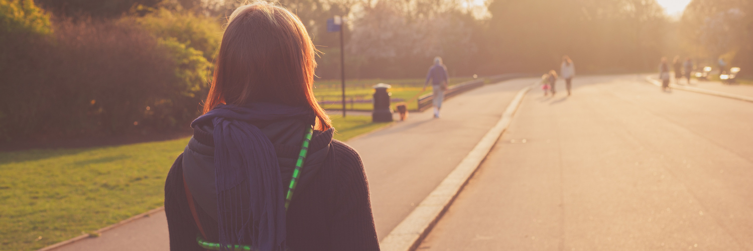 Learning to Celebrate Each Victory Along My Anxiety Journey Woman walking on path through park at sunset
