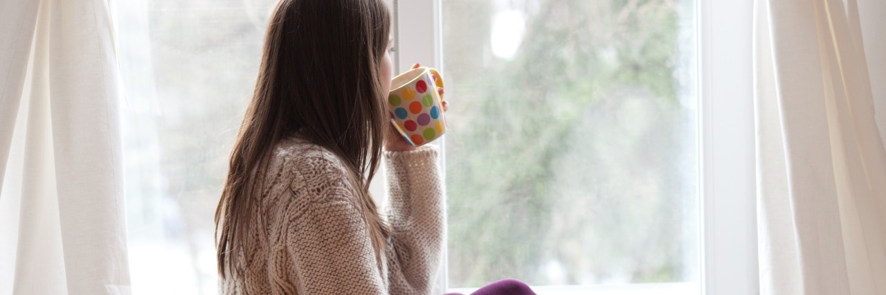 Chronic Illness: Feeling Jealous of Other People's Normalcy woman drinking tea and looking out the window