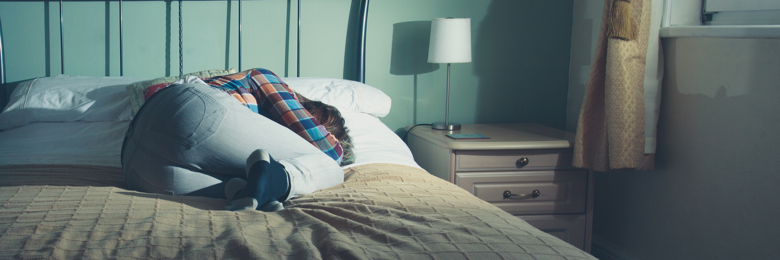 What You Call Minuscule, I Call Critical: A Daily OCD Ritual woman lying on bed alone in dark room